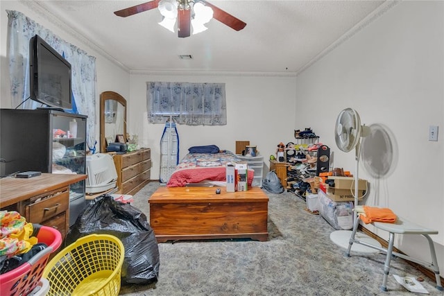 carpeted bedroom featuring ceiling fan, ornamental molding, and a textured ceiling