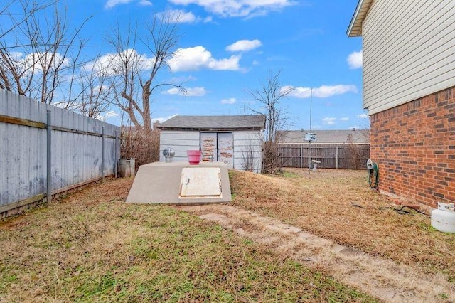 entry to storm shelter featuring a storage shed and a lawn