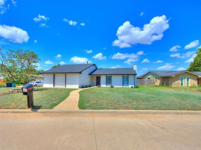 view of front of property with a garage and a front yard