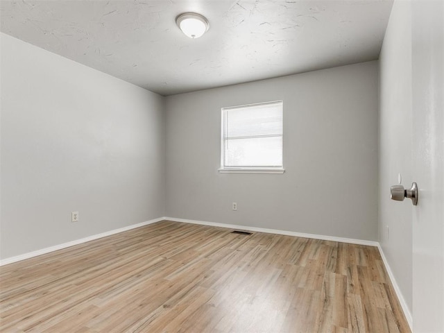 unfurnished room featuring light hardwood / wood-style flooring