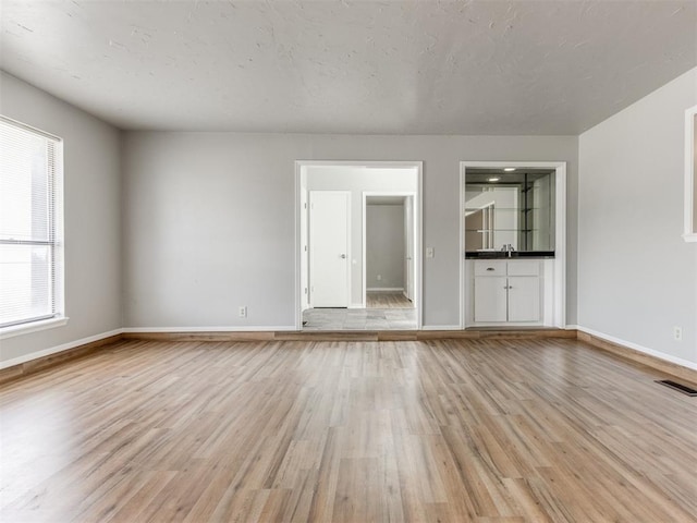 unfurnished living room with light hardwood / wood-style flooring