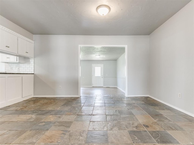 unfurnished room with a textured ceiling