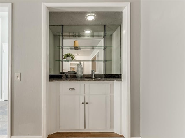 bar featuring indoor wet bar and a sink