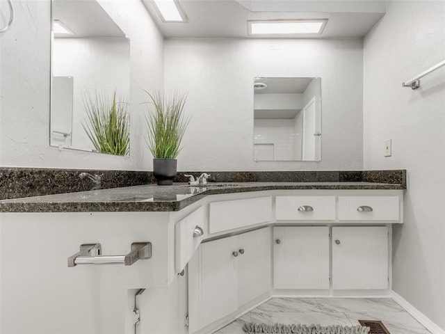 bathroom featuring visible vents, marble finish floor, and a sink