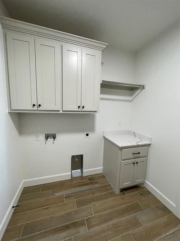 laundry room featuring cabinets, gas dryer hookup, and electric dryer hookup