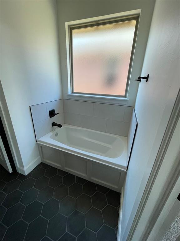 bathroom featuring a bath and tile patterned floors