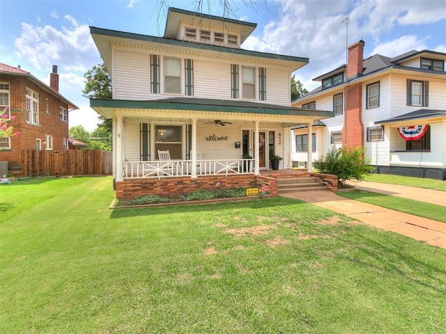 view of front of home with a front lawn, central air condition unit, and a porch