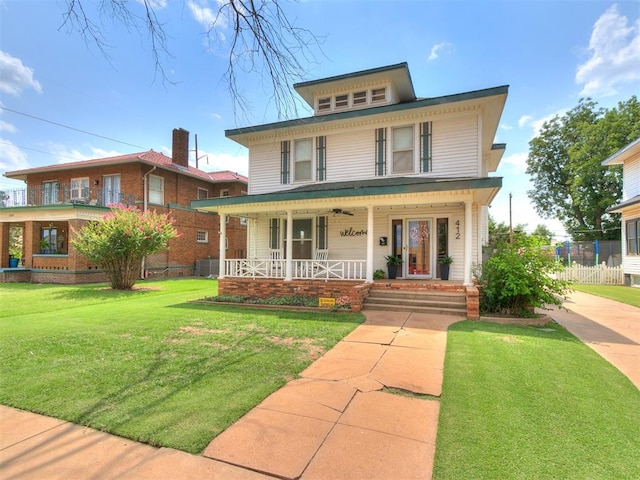 view of front of house featuring covered porch and a front lawn