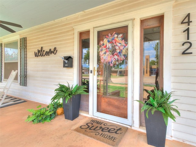 view of exterior entry featuring ceiling fan