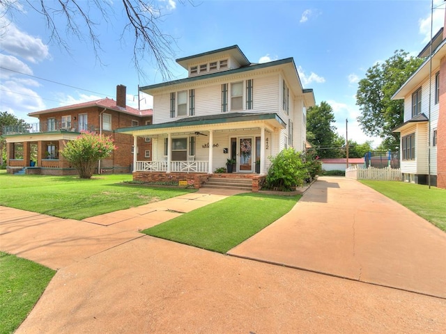 view of front facade with a front yard and covered porch