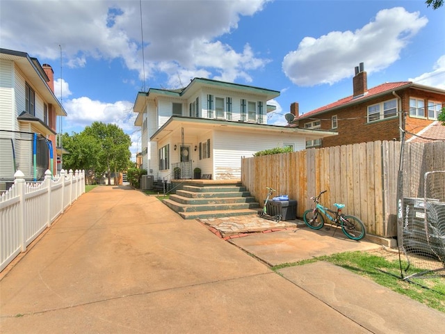 rear view of property featuring central AC and a patio