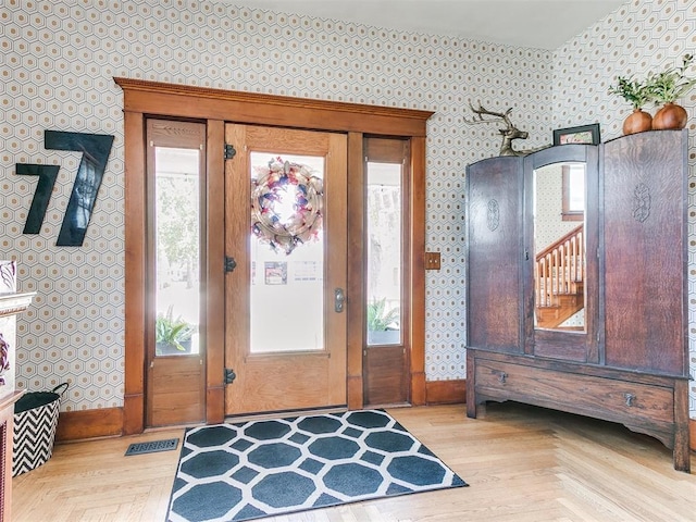 entrance foyer featuring light parquet floors