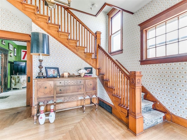 stairway featuring parquet floors