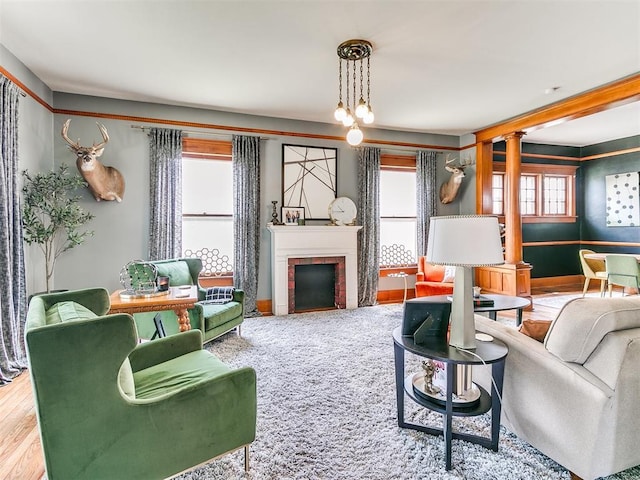 carpeted living room featuring ornate columns