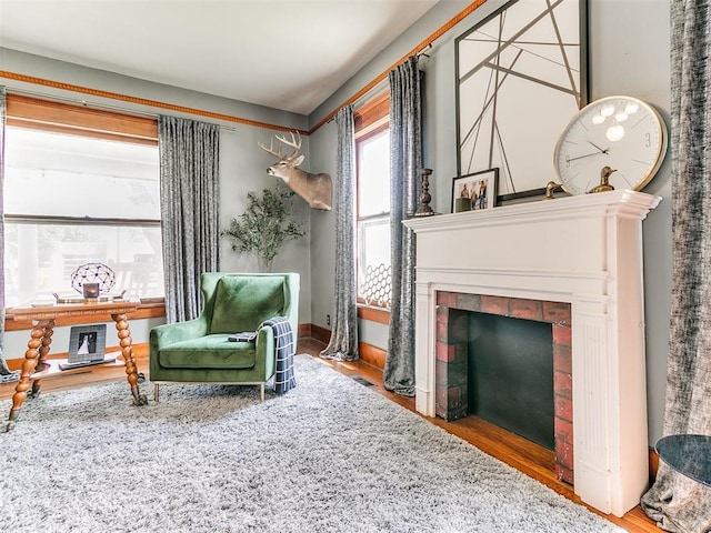 sitting room with hardwood / wood-style flooring and a tile fireplace