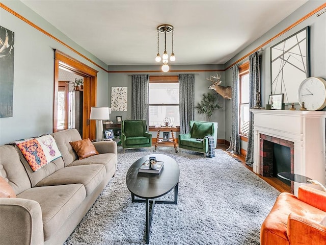 living room with hardwood / wood-style flooring, a wealth of natural light, and a fireplace