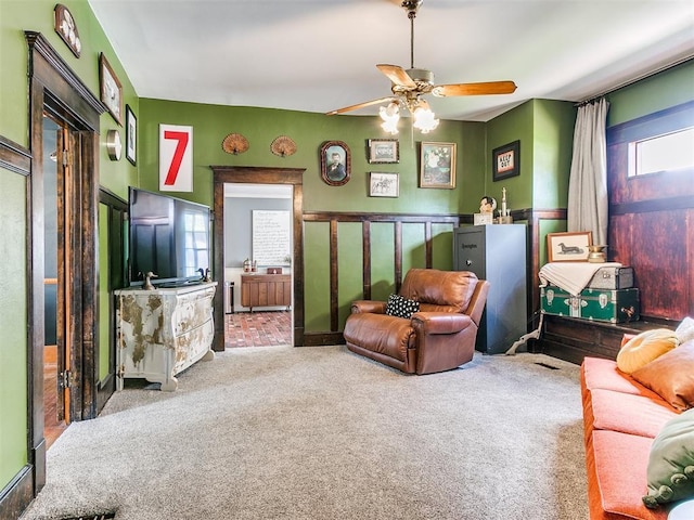 carpeted living room featuring ceiling fan