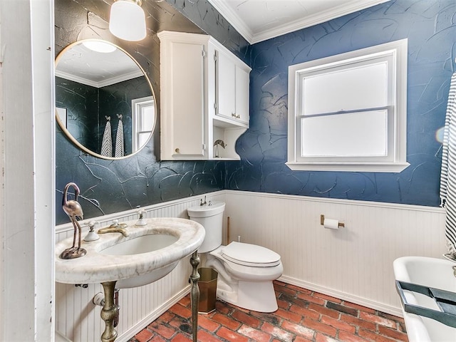 bathroom featuring crown molding and toilet