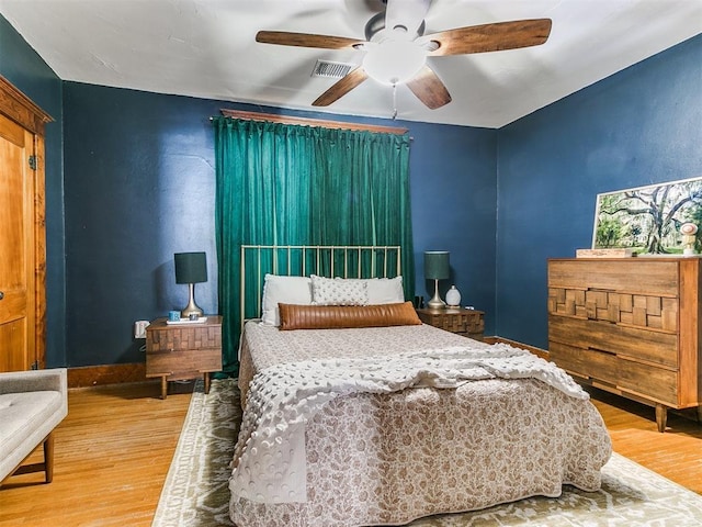 bedroom with ceiling fan and hardwood / wood-style floors