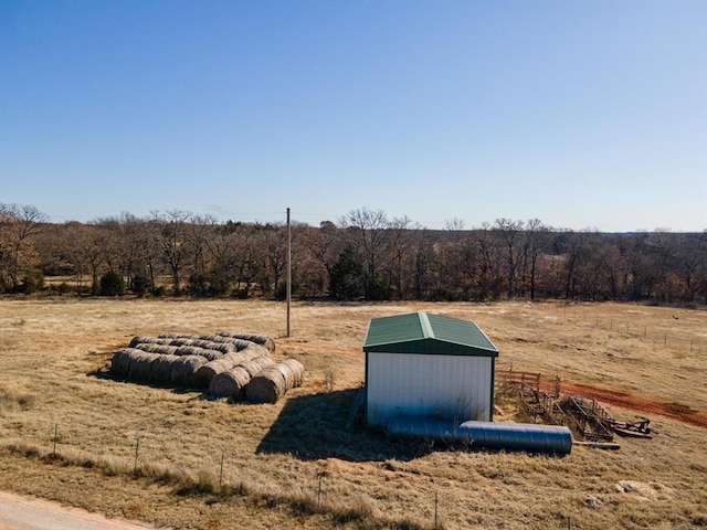 view of storm shelter with a rural view