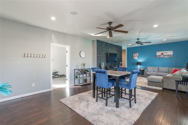 dining space featuring recessed lighting, dark wood-style flooring, and baseboards