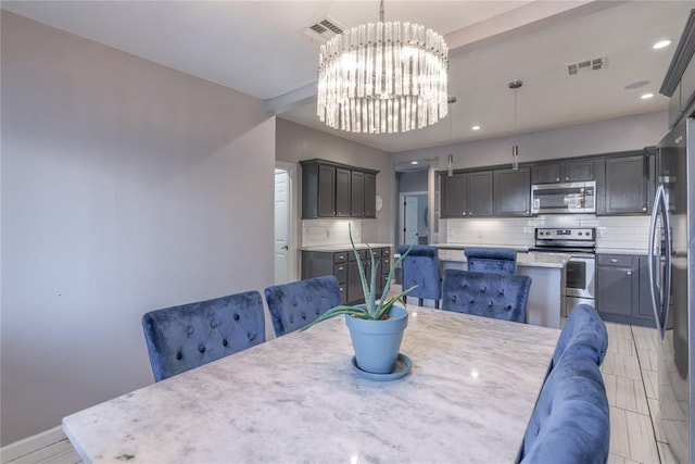 dining area featuring recessed lighting, visible vents, and a notable chandelier