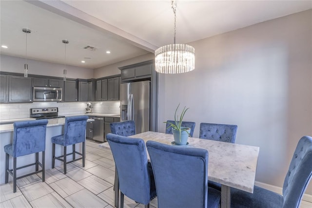 dining space featuring recessed lighting, visible vents, baseboards, and an inviting chandelier