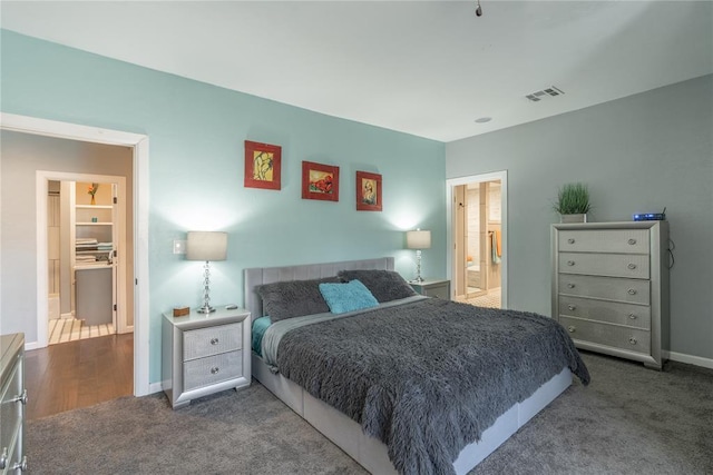 carpeted bedroom featuring baseboards and visible vents