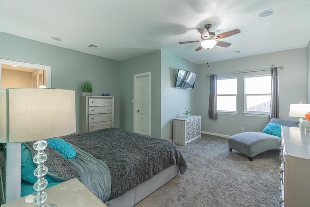 bedroom featuring a ceiling fan, carpet flooring, visible vents, and baseboards