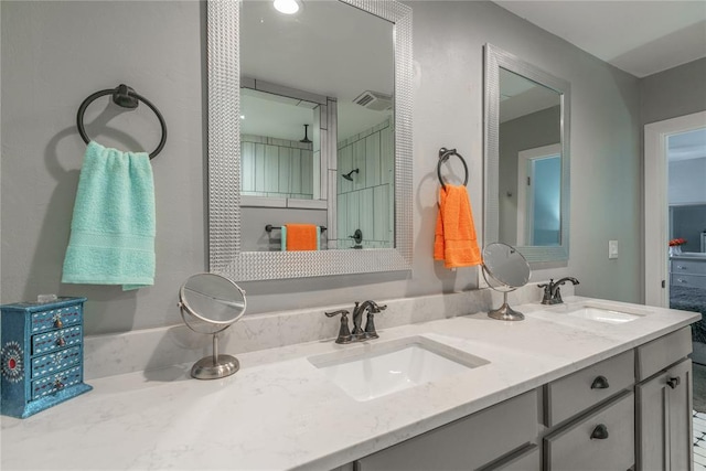 full bath featuring double vanity, a sink, and visible vents