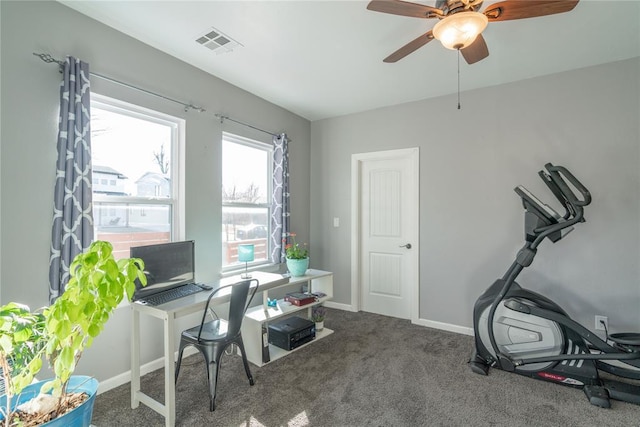 office space with carpet floors, baseboards, visible vents, and a ceiling fan