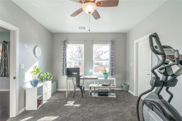 interior space with carpet floors, a ceiling fan, visible vents, and baseboards