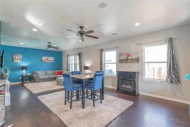 dining space featuring dark wood-type flooring, recessed lighting, visible vents, and baseboards