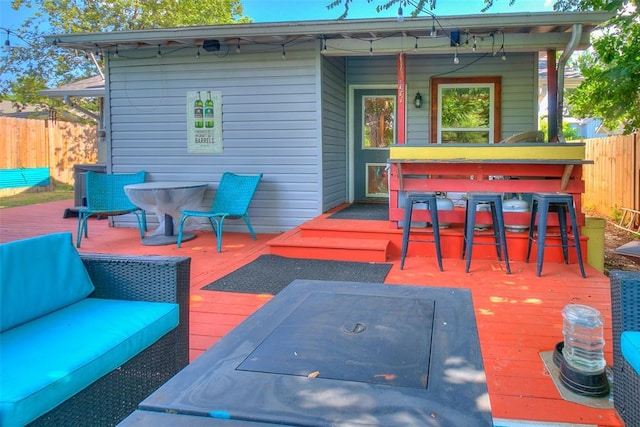 wooden terrace featuring fence and an outdoor hangout area