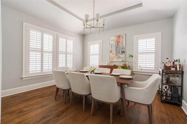 dining room with an inviting chandelier, wood finished floors, baseboards, and a wealth of natural light