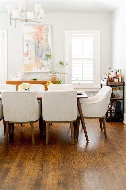 dining space with wood finished floors and a chandelier