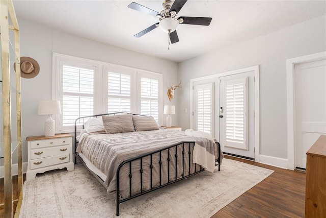 bedroom featuring access to exterior, ceiling fan, baseboards, and wood finished floors