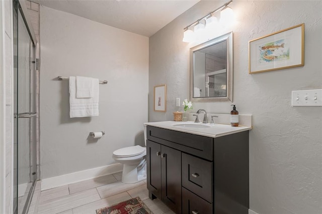 full bath with an enclosed shower, baseboards, toilet, and vanity