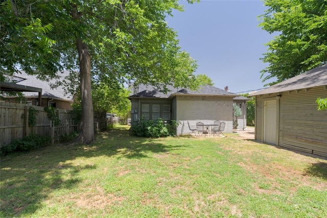 view of yard featuring an outbuilding and fence