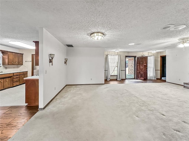 carpeted empty room with a textured ceiling