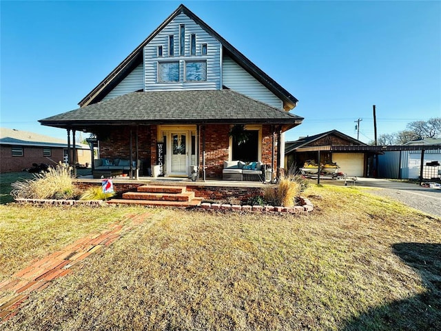 view of front of home featuring a garage, covered porch, and a front lawn