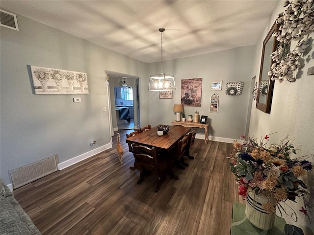 dining area featuring dark wood-type flooring