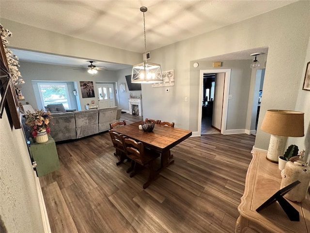 dining space with ceiling fan and dark hardwood / wood-style flooring