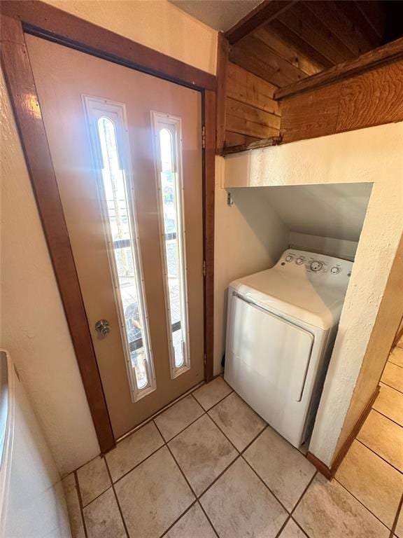 clothes washing area featuring washer / clothes dryer and light tile patterned flooring