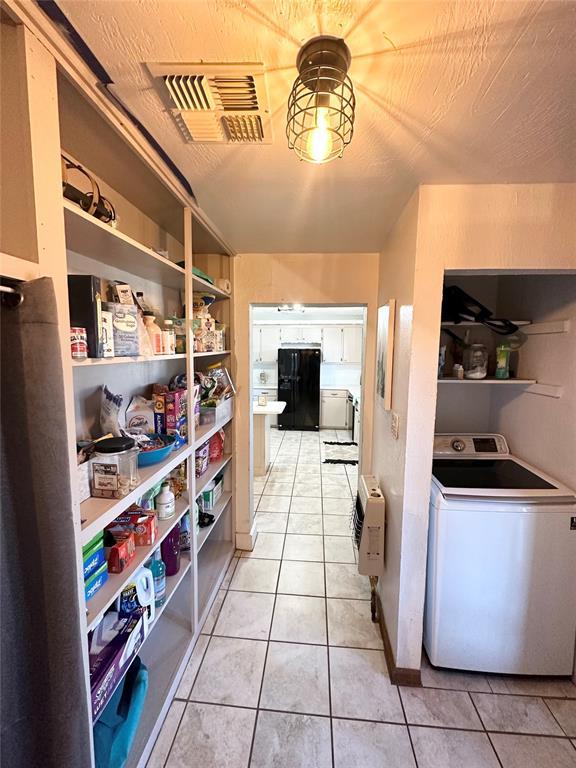 interior space featuring heating unit and washer / clothes dryer