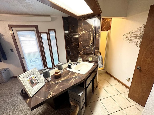 bathroom featuring tile patterned flooring, sink, and a textured ceiling