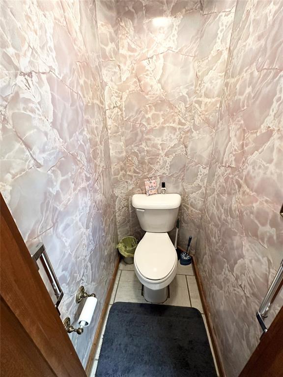 bathroom with tile patterned flooring and toilet