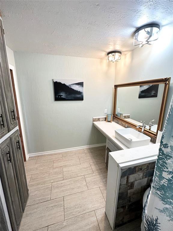 bathroom with vanity and a textured ceiling