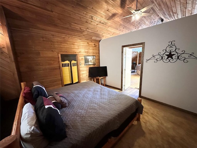 carpeted bedroom featuring ceiling fan, wood walls, vaulted ceiling, and wooden ceiling