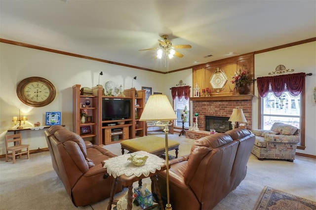 living room with a brick fireplace, crown molding, light colored carpet, and ceiling fan